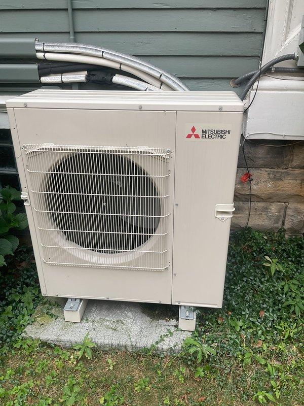 Completed cooling tune-up on multi-zone Mitsubishi Electric heat pump system consisting of 2 outdoor condensing units serving 9 total indoor air handlers. Inspected both outdoor units, verified proper operation of electrical contactors and relays, checked refrigerant line connections, and confirmed all components functioning within normal parameters.