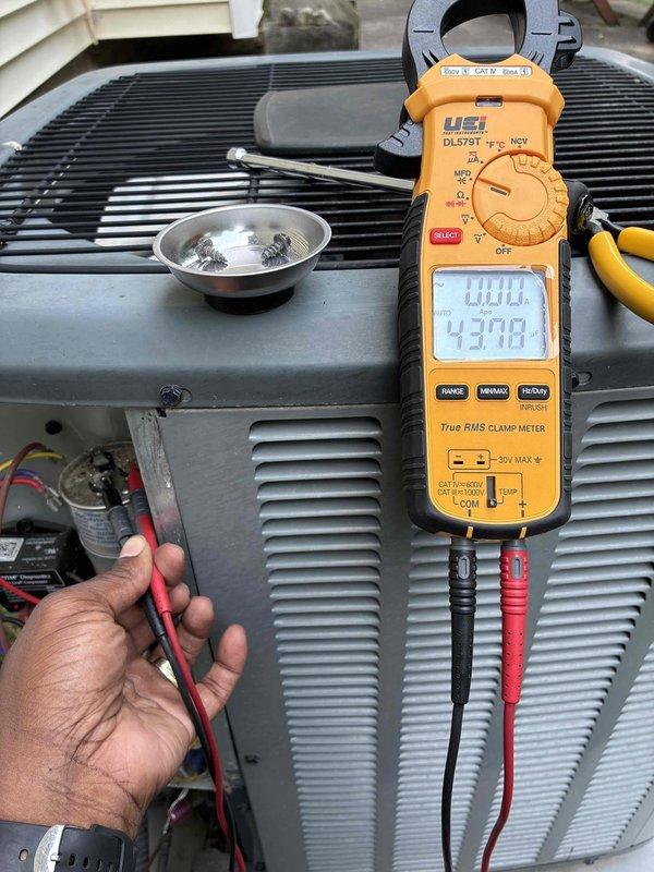 # HVAC Cooling Maintenance Summary

Completed scheduled preventive maintenance on residential air conditioning system. Performed comprehensive electrical diagnostics using digital clamp meter, measuring operating amperage at 43.98 amps to verify proper compressor and condenser fan motor performance. Inspected condenser unit exterior components and ventilation grilles, noting accumulated debris and particulate buildup behind louver fins that could restrict airflow. System operational parameters verified within normal range.

# Detailed Service Report

Performed routine preventive maintenance inspection on residential split-system air conditioning unit as part of ongoing maintenance agreement. Conducted thorough electrical diagnostics to assess system performance and component health.

**Electrical Testing and Diagnostics:**
Utilized UEI DL279T True RMS clamp meter to measure operating electrical current. Recorded amperage reading of 43.98 amps during system operation. Verified proper el