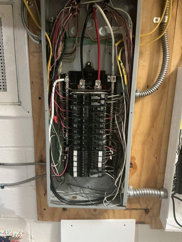 Installed new subpanel in exposed wooden frame wall with proper metallic flexible conduit routing and complete circuit breaker configuration across two vertical columns. Performed comprehensive panel repair work including main disconnect servicing, bus bar connections, and proper wire management for multiple branch circuits using color-coded conductors. Installed Generac transfer switch equipment with appropriate mounting, conduit connections, and integration with existing electrical infrastructure to ensure code-compliant operation.
