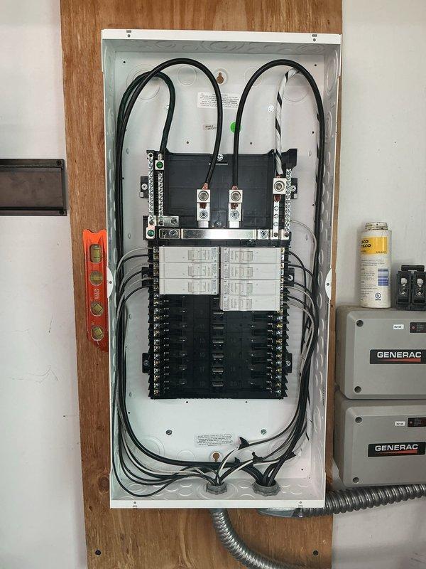Installed new subpanel in exposed wooden frame wall with proper metallic flexible conduit routing and complete circuit breaker configuration across two vertical columns. Performed comprehensive panel repair work including main disconnect servicing, bus bar connections, and proper wire management for multiple branch circuits using color-coded conductors. Installed Generac transfer switch equipment with appropriate mounting, conduit connections, and integration with existing electrical infrastructure to ensure code-compliant operation.
