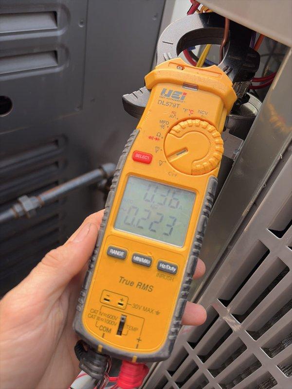 Completed comprehensive cooling season tune-up on residential outdoor condensing unit. Performed electrical diagnostics using clamp meter to verify proper amperage draw on compressor and condenser fan motor, inspected capacitor and all electrical connections for proper operation, and documented equipment condition through detailed photography. All components found operating within normal parameters with wiring connections secure and unit functioning properly for continued cooling season operation.