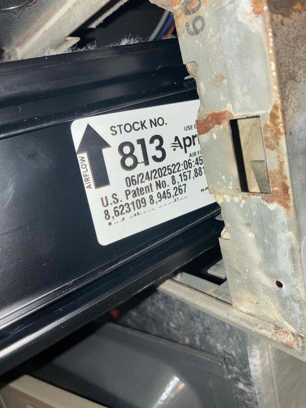 # HVAC Cooling Maintenance - Two System Service

Completed comprehensive preventive maintenance service on two cooling systems as part of ongoing recurring maintenance program. Performed thorough inspection of both units, including examination of condenser coils, heat exchanger components, and airflow pathways. 

First system inspection revealed stock unit #813 with proper airflow direction labeling intact. Noted moderate corrosion present on metal framework and support structures, consistent with normal aging and environmental exposure. Heat exchanger fins and ribbed components inspected and found operational, though frame deterioration documented for monitoring.

Second unit presented with significant dirt accumulation and debris buildup on exterior grille and louvers. Dark streaking and grime visible throughout horizontal slat assembly, with concentrated soiling in airflow channels. Condenser coils behind grille showed dust and debris infiltration. External housing mounted on buildi