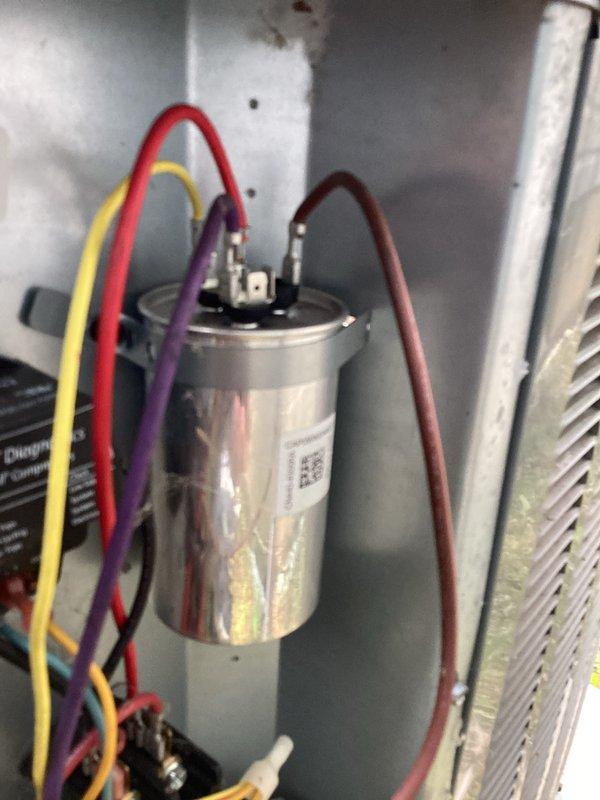 Completed comprehensive cooling system tune-up on residential HVAC unit. Performed standard maintenance procedures including inspection of dual-run capacitor with multi-wire connections, verified proper electrical connections at outdoor disconnect switch, and confirmed all system components operating within normal parameters.