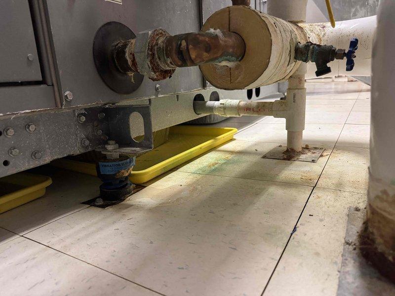 Responded to service call for excessive water leakage from industrial air conditioning units in church attic causing discharge into building below. Upon inspection, identified blocked condensate drain lines on 11-year-old AC system as primary cause of water intrusion. Cleared obstructed drain lines, verified proper drainage flow, and tested system operation to ensure condensate was being properly evacuated from units without further leakage into occupied space below.