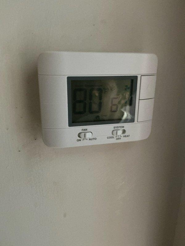 Conducted comprehensive assessment of 40-year-old HVAC system located in attic for full replacement estimate. Evaluated existing thermostat operation and documented system accessibility challenges due to attic configuration. Noted significant debris accumulation and deteriorated conditions around exterior equipment, indicating extended service life and need for complete system replacement with updated equipment and proper clearances.