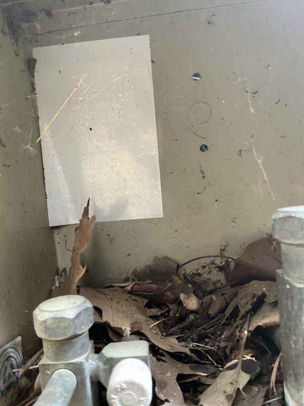 Conducted comprehensive assessment of 40-year-old HVAC system located in attic for full replacement estimate. Evaluated existing thermostat operation and documented system accessibility challenges due to attic configuration. Noted significant debris accumulation and deteriorated conditions around exterior equipment, indicating extended service life and need for complete system replacement with updated equipment and proper clearances.