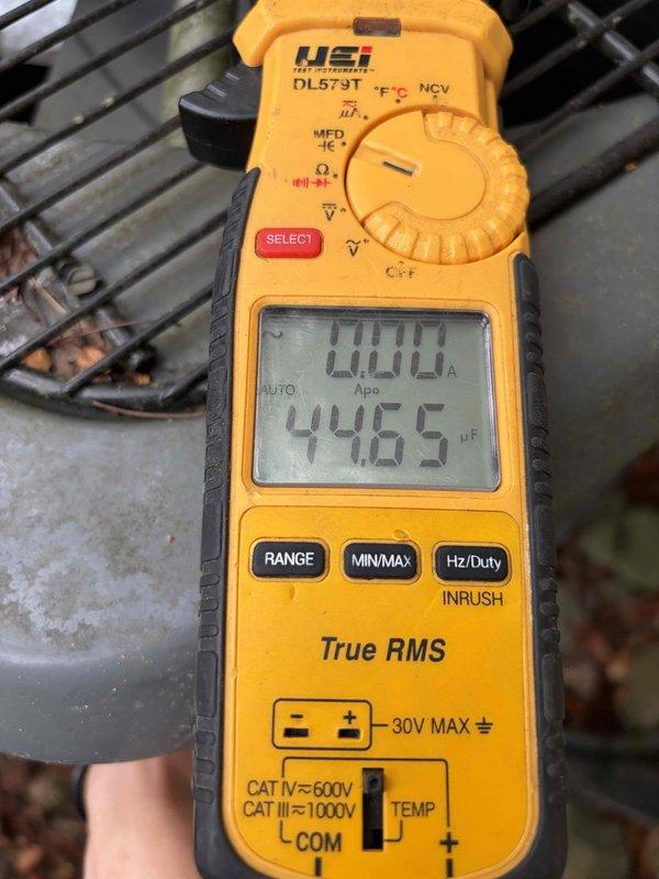 Completed scheduled preventative maintenance on residential cooling system. Upon arrival, found significant dust and debris accumulation on ventilation grille with visible cobwebbing and possible mold growth, indicating extended period without service. Thoroughly cleaned all accessible components and tested system capacitance readings using digital multimeter, confirming proper electrical function at 44.65 μF. Unit restored to optimal operating condition.