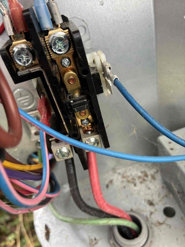 Completed routine HVAC cooling system maintenance including inspection of electrical connections and terminal blocks within the unit's control panel. Verified proper wire terminations, checked for signs of wear or corrosion on brass terminals, and confirmed secure connections across all colored control wiring. All electrical components found to be functioning within normal parameters with connections properly secured.