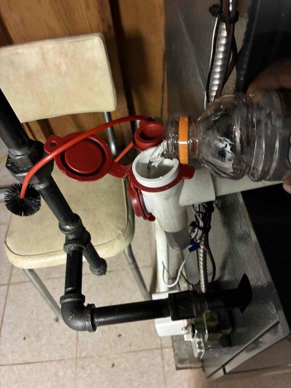 Completed routine HVAC cooling system maintenance including inspection of electrical connections and terminal blocks within the unit's control panel. Verified proper wire terminations, checked for signs of wear or corrosion on brass terminals, and confirmed secure connections across all colored control wiring. All electrical components found to be functioning within normal parameters with connections properly secured.