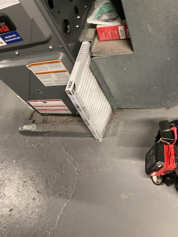 Completed routine cooling maintenance on residential HVAC system, including replacement of pleated air filter and comprehensive inspection of unit components. All warning labels, refrigerant notices, and warranty documentation verified as present and legible, with condensate drainage lines and electrical connections confirmed operational and secure.
