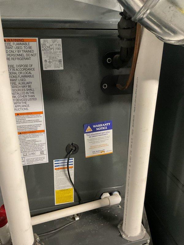 Completed routine cooling maintenance on residential HVAC system, including replacement of pleated air filter and comprehensive inspection of unit components. All warning labels, refrigerant notices, and warranty documentation verified as present and legible, with condensate drainage lines and electrical connections confirmed operational and secure.