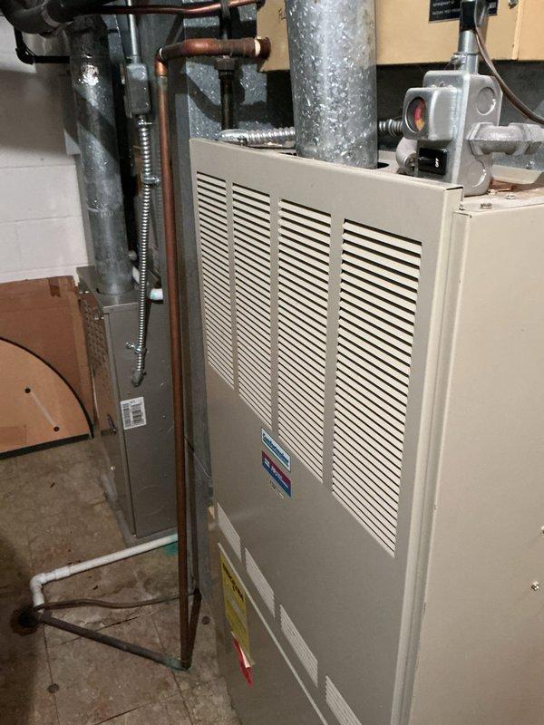 # Mini Split System Diagnostic and Repair

Responded to service call for non-operational mini split cooling system. Property has two mini split units aged 9 and 11 years respectively. Upon arrival, performed comprehensive diagnostic testing on both outdoor condensing units and indoor air handlers.

Utilized digital multimeter to test electrical components on the Trane XE 1000 outdoor unit. Measured voltage and amperage at compressor, contactor, and capacitor to identify potential electrical failures. Noted significant weathering and debris accumulation on outdoor unit surfaces, including biological growth on top panel which can impede heat transfer efficiency.

Inspected refrigerant line sets connecting outdoor units to indoor air handlers. Verified integrity of insulation on copper refrigerant lines running through basement utility area. Checked for refrigerant leaks using appropriate detection methods at all connection points and service valves.

Evaluated indoor furnace and air hand