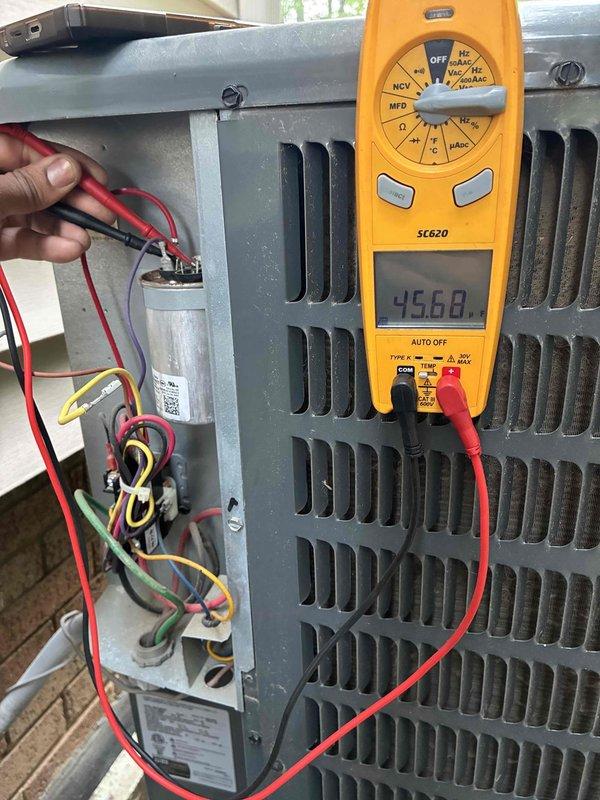 # HVAC Cooling Maintenance - Two Systems

Performed comprehensive preventive maintenance on two air conditioning systems as part of recurring service agreement. Conducted electrical diagnostics on outdoor condensing unit using Fieldpiece SC620 clamp meter, measuring amp draw and verifying proper electrical function. Inspected and tested dual run capacitor, confirming proper microfarad ratings and electrical connections with red, yellow, green, and white wire terminations secure and within specifications.

Evaluated refrigerant line insulation integrity on copper linesets, noting foam insulation properly secured with cable ties. Measured system performance parameters using calibrated digital instruments to verify operational efficiency and proper refrigerant charge. Documented equipment condition with photographic records showing standard outdoor wear consistent with normal operation. All electrical components, including capacitor and wiring connections within electrical compartment, fo