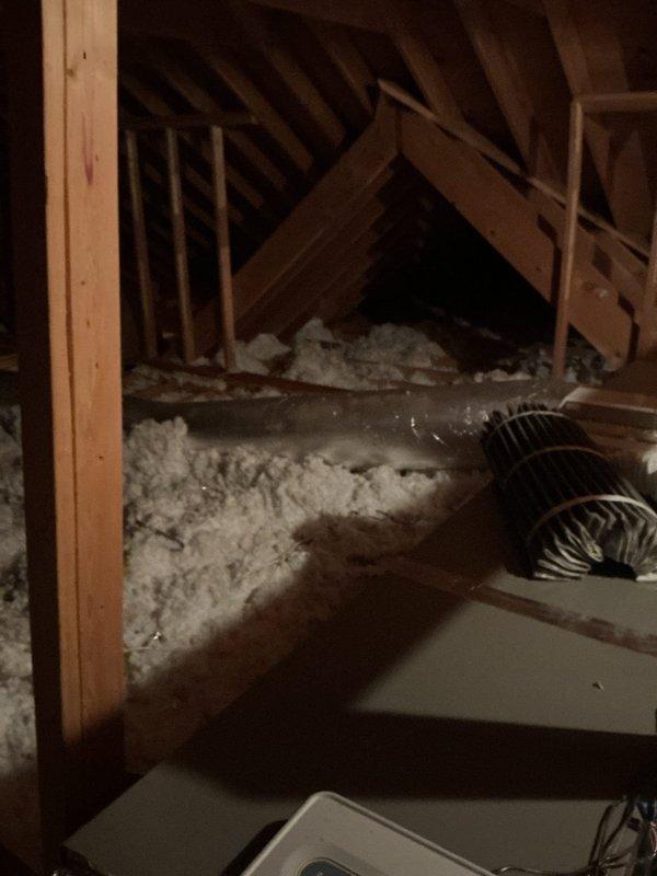 Responded to no cooling complaint and performed system inspection. Accessed attic-mounted HVAC equipment and inspected ductwork installation, insulation coverage, and air distribution components. Verified proper duct connections and documented existing system configuration with flexible ductwork running through insulated attic space.