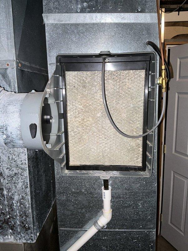 Conducted on-site evaluation of existing HVAC system to assess cooling capacity concerns and provide replacement options. Inspected indoor air handler unit located in attic space, including blower assembly, filter housing, and condensate drain configuration. Evaluated outdoor condensing unit condition, noting weathered exterior casing and examining condenser coil fins for debris accumulation and operational wear. Documented current equipment specifications from manufacturer data plate for proper sizing calculations. Photographed existing system components to support replacement recommendations addressing undersized equipment concerns. Provided customer with multiple equipment options for system replacement to achieve adequate cooling capacity for the residence.