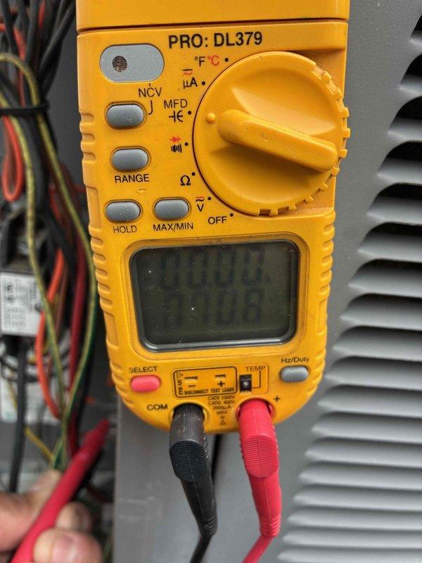 Completed heating maintenance tune-up on residential furnace system. Identified condensate drain line with active water leakage due to inadequate sealing; sealed white PVC condensate pipe to eliminate moisture discharge. Performed comprehensive system diagnostics using digital multimeter to verify electrical components, tested voltage readings, and confirmed proper amperage draw at outdoor disconnect panel. All heating components operating within manufacturer specifications following repairs.