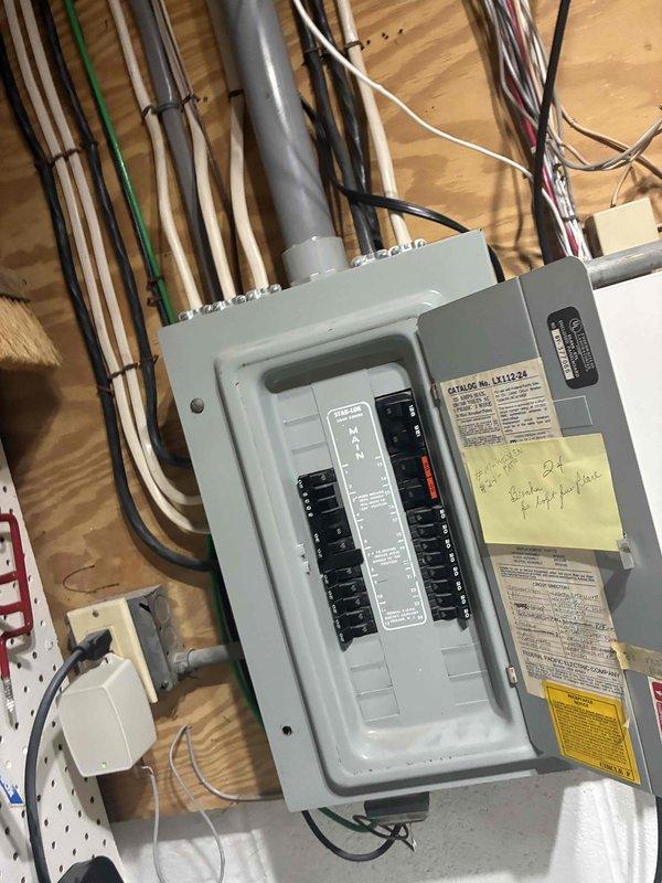 Responded to callback for recurring water leak in utility room from air conditioning system. Previous service visit on 7/10 had addressed initial water leak, but large amounts of water were again accumulating on the floor. Performed visual inspection of the affected area and documented conditions with photographs showing the utility room layout, electrical panel, and flooring where water accumulation was occurring. Further diagnostics required to identify root cause of persistent condensate drainage issue.