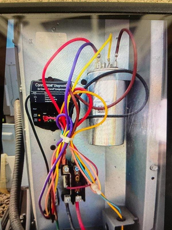 Completed comprehensive cooling system tune-up on residential HVAC unit. Performed full system inspection including electrical control panel examination, verified proper operation of CoreSense diagnostic system for compressor monitoring, checked all wire connections and terminals for secure contact, tested capacitor functionality, and inspected contactor relay operation. Outdoor condensing unit inspected for proper airflow through top grille and verified all access panels secure. System operating within normal parameters upon completion.