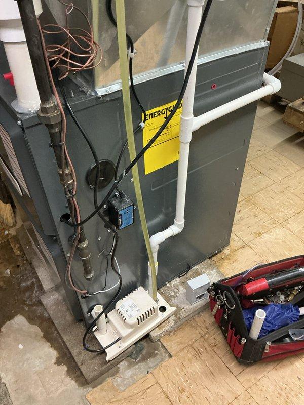 Responded to customer concern regarding water leakage in basement near condensation pump. Upon inspection, verified furnace operation and examined air filtration system, noting dust accumulation in filter compartment. Inspected HVAC unit installation including copper refrigerant lines, PVC condensate drainage system, and electrical connections to identify source of reported leak and ensure proper system function.