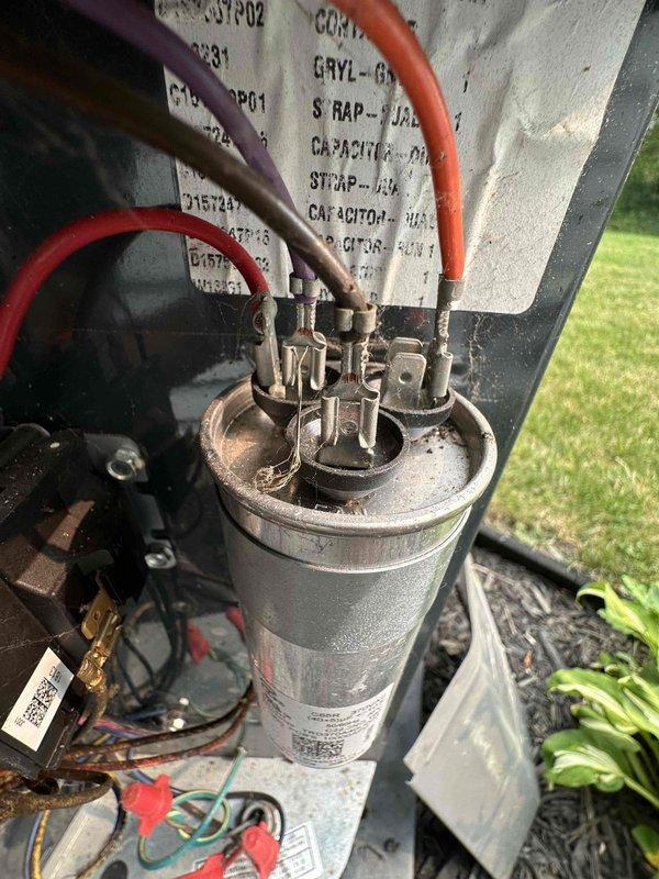 Completed scheduled cooling system maintenance on residential outdoor condensing unit. Performed comprehensive inspection of electrical components including capacitor and contactor, verified all wire connections were secure, and confirmed unit operational status. Equipment showing normal wear consistent with outdoor installation; system functioning within specifications.