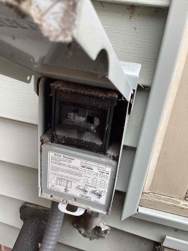 Completed seasonal cooling system tune-up on residential air conditioning unit. Performed comprehensive inspection of outdoor condenser unit, checked refrigerant levels, cleaned coils, tested electrical connections at weathered disconnect box, verified proper airflow through louvers, and confirmed system operation within manufacturer specifications. Unit showed age-related wear but maintained functional performance throughout diagnostic testing.