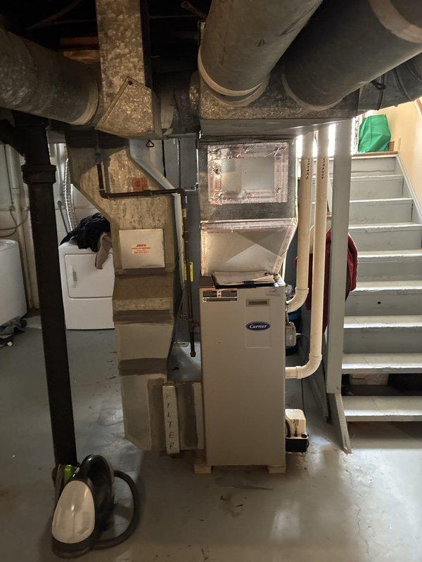 Conducted comprehensive HVAC system evaluation for residential property with existing 2010 Carrier furnace installation. Assessed current heating system condition, evaluated ductwork infrastructure showing age-related wear and dust accumulation, and provided complete system replacement options including add-on air conditioning configurations. Documented existing basement mechanical room layout with measurements and prepared detailed proposal drawings outlining equipment placement, venting requirements, and system specifications for full HVAC system upgrade to address aging equipment concerns.