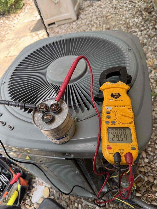 Completed cooling season tune-up on outdoor condensing unit, including electrical diagnostics and visual inspection of internal components. Tested capacitor voltage and amperage readings using digital multimeter, verified electrical connections, and assessed condition of evaporator coils which showed accumulation of dust and debris on fins. All electrical components accessible and functioning within normal parameters at time of service.