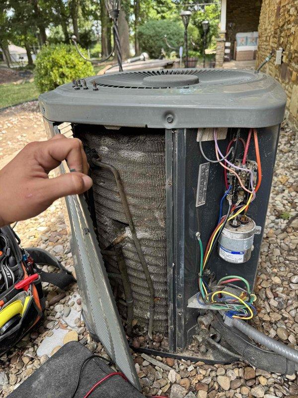 Completed cooling season tune-up on outdoor condensing unit, including electrical diagnostics and visual inspection of internal components. Tested capacitor voltage and amperage readings using digital multimeter, verified electrical connections, and assessed condition of evaporator coils which showed accumulation of dust and debris on fins. All electrical components accessible and functioning within normal parameters at time of service.