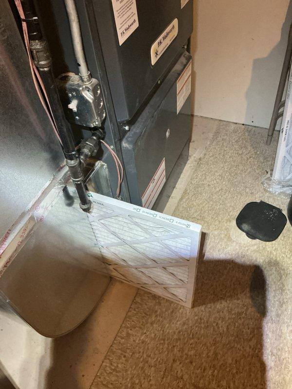 Completed routine HVAC cooling maintenance on residential system, performing standard inspection of furnace unit and associated components. Verified proper operation of condensate drain system with U-trap configuration, checked refrigerant lines and connections, and confirmed all safety labels and equipment specifications were clearly visible and intact.
