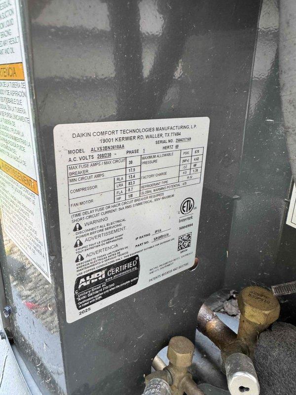 Responded to no-cooling call on one-year-old Daikin outdoor unit. Found red fault indicator illuminated at exterior disconnect box indicating blown fuse. Diagnosed failed fuse preventing power to condensing unit. Replaced defective fuses in outdoor disconnect, verified proper amperage rating per manufacturer specifications, restored power to system, and confirmed unit operation with normal cooling restored.