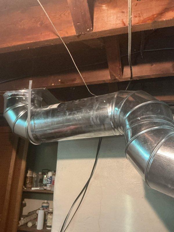 Responded to callback for 9-year-old air conditioning system that failed after recent repair. Inspected outdoor condenser unit and traced refrigerant lines through basement mechanical space. Examined exposed ductwork system in unfinished basement area, checking for airflow restrictions and verifying proper installation of galvanized metal supply ducts with curved elbow joints. Confirmed ductwork integrity and secure mounting with metal strapping. Identified and resolved original failure point, restoring full system operation. Unit tested successfully with proper cooling output confirmed.