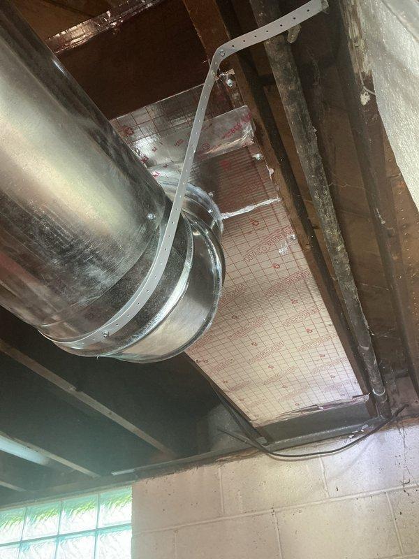 Responded to callback for 9-year-old air conditioning system that failed after recent repair. Inspected outdoor condenser unit and traced refrigerant lines through basement mechanical space. Examined exposed ductwork system in unfinished basement area, checking for airflow restrictions and verifying proper installation of galvanized metal supply ducts with curved elbow joints. Confirmed ductwork integrity and secure mounting with metal strapping. Identified and resolved original failure point, restoring full system operation. Unit tested successfully with proper cooling output confirmed.