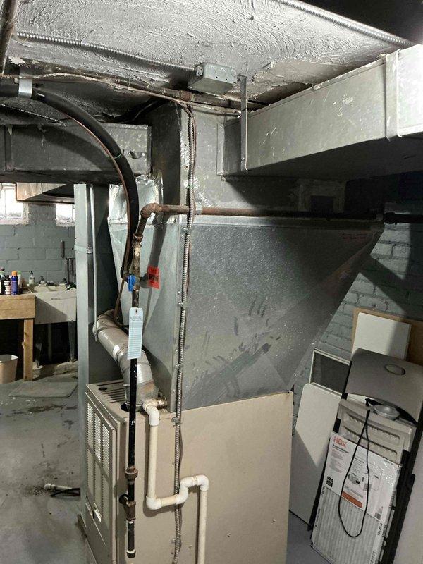 Conducted site evaluation for HVAC system replacement in residential property. Assessed existing furnace, air conditioning condenser unit, and associated ductwork including plenum and refrigerant line configuration. Documented current equipment specifications and installation conditions to provide comprehensive replacement options for aging cooling system.