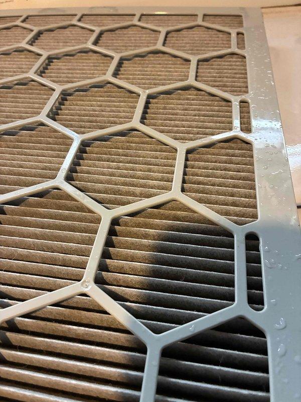 Responded to no cooling complaint on recently installed system. Upon inspection, found severely restricted airflow due to heavily soiled air filters with significant dust and debris accumulation. Removed and documented multiple hexagonal-frame pleated filters showing substantial contamination that was impeding system performance and preventing adequate cooling capacity.