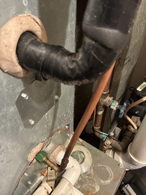 Responded to a no-cool complaint on a 16-year-old Lennox rooftop unit at a condo with two side-by-side RTU installations. Accessed the units via ladder, performed diagnostic assessment, and documented existing mechanical infrastructure including aged copper refrigerant lines, PVC condensate piping, flexible ductwork connections, and associated plumbing components showing typical wear and oxidation consistent with unit age. Provided estimate for complete RTU replacement.