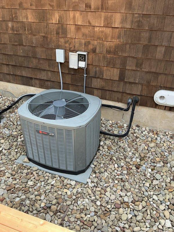 Responded to service call for non-operational upstairs air conditioning unit that had been inoperative for three weeks. Conducted comprehensive system evaluation and documented existing HVAC installation, including outdoor Trane condenser unit with proper mounting on concrete pad and river rock landscaping, electrical disconnect and control panel components, and indoor multi-zone control system featuring three Honeywell zone controllers with associated wiring and junction boxes. Presented replacement options to address the failed upstairs cooling system.