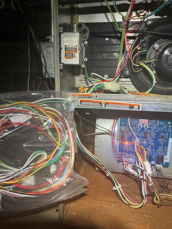 Replaced defective wiring harness on HVAC control system due to damaged wire connections affecting unit operation. Disconnected old harness from control board, installed new harness with proper wire routing and secure connections to all terminals, and verified system functionality upon completion.