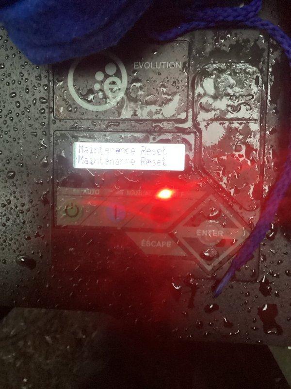 Responded to service call for HVAC system with malfunctioning control panel. Upon inspection, found Evolution-branded electronic control interface experiencing severe moisture intrusion, with extensive water condensation covering all surfaces and internal components. Water droplets were present throughout the control panel housing, compromising electrical connections and creating potential for short circuits. Identified failed gasket as the source of moisture penetration into the sealed control unit.

Documented existing conditions with photographs showing water damage to control panel and LED indicators still functioning despite moisture presence. Replaced defective gasket to restore proper weatherproof seal on control panel enclosure. Thoroughly dried all affected electronic components and verified proper operation of navigation controls, display screen, and indicator lights. Confirmed outdoor condenser unit remained operational with green status light illuminated throughout repair p