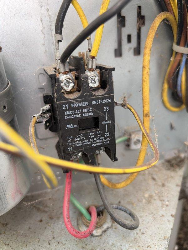 # HVAC Cooling System Maintenance - MVP Service

Performed comprehensive preventive maintenance on an aging outdoor cooling system unit. Conducted thorough inspection of electrical components housed within the exterior-mounted control panel, including the MARS capacitor and Homeis HN51KC024 contactor. 

Evaluated all electrical connections and wiring integrity, noting age-appropriate wear on conductor insulation. Verified proper terminal connections on the 24VAC coil contactor and capacitor assembly. Assessed mounting hardware and panel condition, which showed expected weathering consistent with outdoor installation and extended service life.

All critical electrical components were inspected and found to be operational. System electrical connections were secure and functioning within normal parameters. Unit cleared for continued operation following maintenance protocol completion.