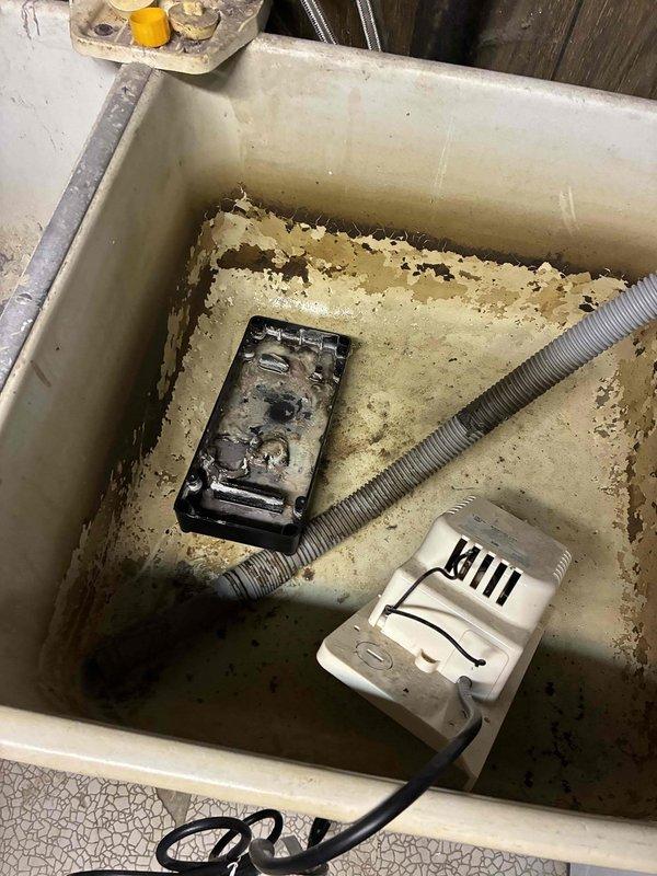 Responded to customer report of large amounts of water accumulating in basement when air conditioning system was running. Upon inspection, found condensate drainage system failure causing water to overflow onto basement floor, resulting in extensive water damage to flooring surfaces around floor register area. Identified failed condensate pump in utility sink area and addressed drainage issue to prevent further water accumulation.