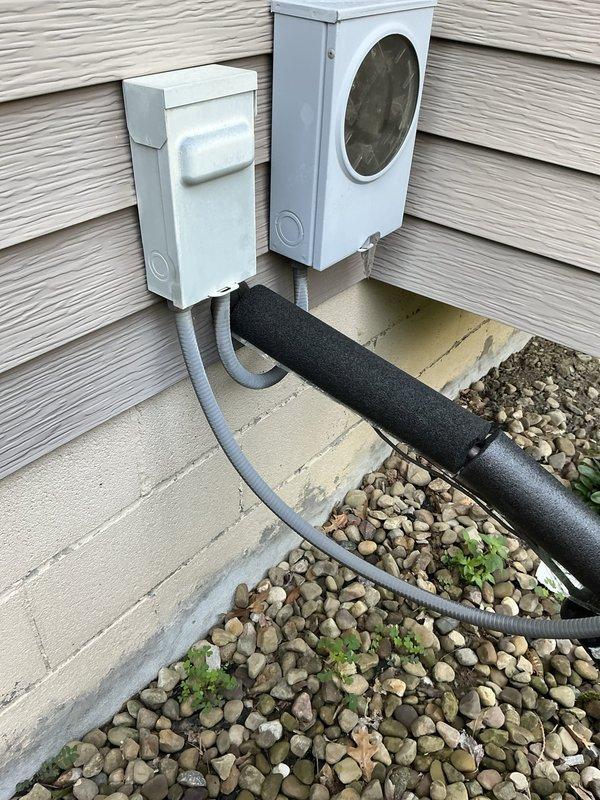 Conducted comprehensive evaluation of 32-year-old HVAC system for full replacement estimate. Assessed existing exterior condenser unit, electrical disconnect components, refrigerant line routing with insulation, and documented installation challenges including refrigerant lines running through 5-foot crawlspace access area. Photographed current equipment configuration, line set covers, electrical connections, and foundation-level installation conditions to provide detailed replacement options for customer consideration.
