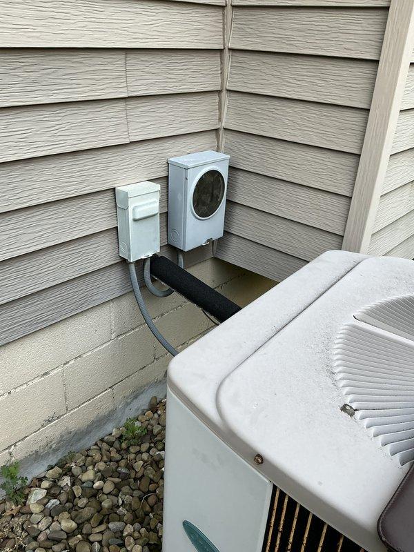 Conducted comprehensive evaluation of 32-year-old HVAC system for full replacement estimate. Assessed existing exterior condenser unit, electrical disconnect components, refrigerant line routing with insulation, and documented installation challenges including refrigerant lines running through 5-foot crawlspace access area. Photographed current equipment configuration, line set covers, electrical connections, and foundation-level installation conditions to provide detailed replacement options for customer consideration.