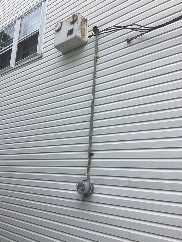 Conducted comprehensive electrical panel assessment at residential property. Evaluated existing exterior electrical service equipment including meter base, main disconnect, and associated conduit system mounted on building exterior. Documented current panel configuration, connection integrity, and overall system condition through detailed photographic documentation to support estimate preparation for panel upgrade or replacement work.