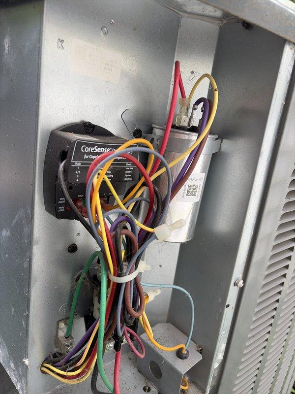 Completed scheduled preventive maintenance on residential cooling system. Performed electrical diagnostics using clamp meter, recording amperage readings of 40.21A and 13.75A to verify proper compressor and system operation. Accessed unit control panel to inspect wiring connections and CoreSense diagnostic module for Copeland compressor system, confirming all electrical components functioning within normal parameters.
