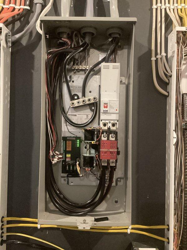Provided comprehensive electrical estimate for backup generator installation at residential property. Evaluated existing 200-amp main service panel and HVAC zoning system to determine optimal integration point for automatic transfer switch and generator interconnection. Assessed electrical loads including tankless Rinnai water heater, Arzel zoning control system, and existing branch circuits to calculate required generator capacity and transfer switch specifications for seamless emergency power backup during utility outages.