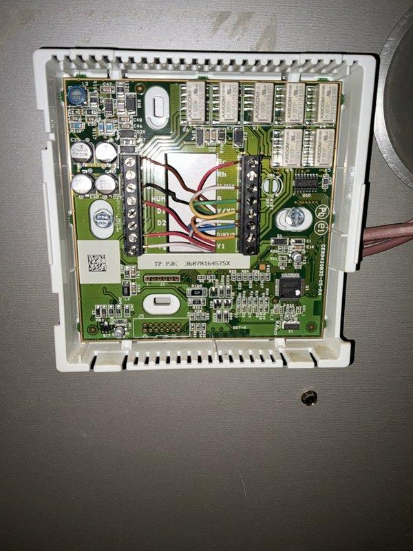 Conducted comprehensive site evaluation for full HVAC system replacement, presenting heat pump with backup heat options to customer. Documented existing equipment configuration including outdoor condensate drainage assembly and indoor control board wiring for replacement specifications.