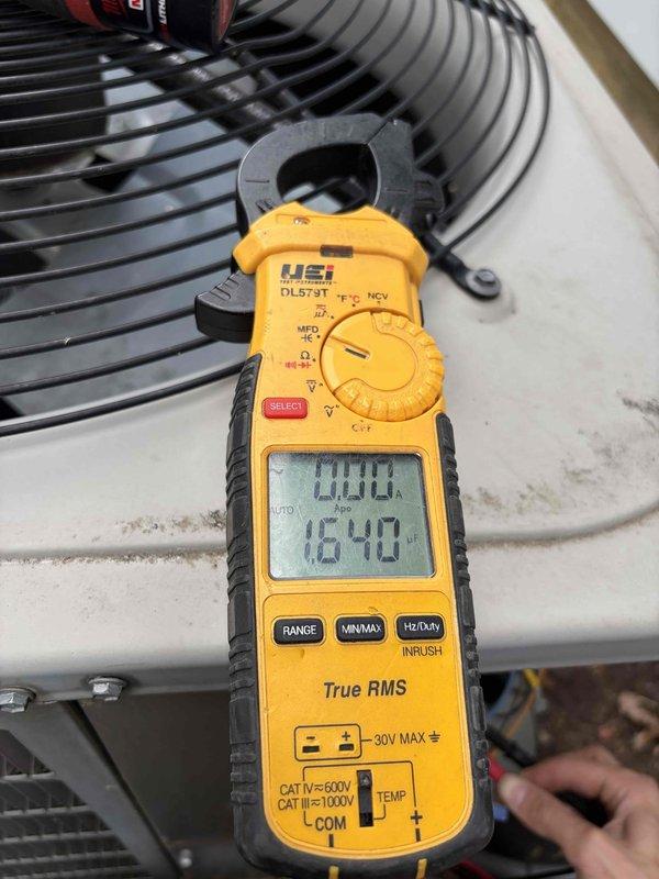 Completed comprehensive air conditioning tune-up service on residential HVAC system. Inspected and tested electrical components including fuse assembly and disconnect panel, verified proper amperage draw on condenser fan motor reading 16.40 amps, and confirmed system operational performance within manufacturer specifications.