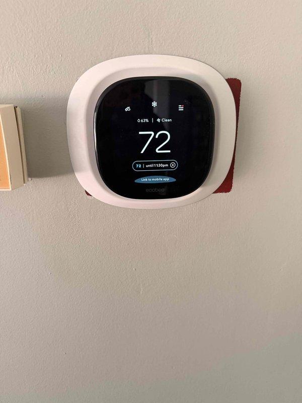 Completed installation of Ecobee3 smart thermostat with remote temperature sensor. Mounted main thermostat unit on wall and positioned wireless room sensor on baseboard for enhanced zone temperature monitoring. Verified system connectivity and configured mobile app integration for remote access and control.