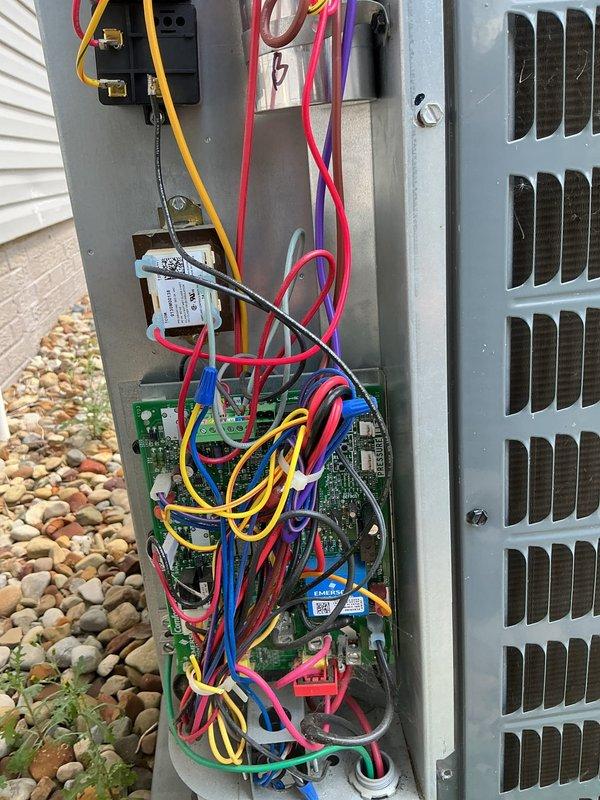 Responded to service call for 5-year-old air conditioning system experiencing recurring loss of cooling requiring breaker resets. Accessed outdoor unit electrical compartment and performed diagnostic evaluation of control boards, wiring connections, and capacitor. Reviewed fault code history and inspected internal electrical components including dual circuit boards, terminal connections, and capacitor mounting. System exhibited signs of potential electrical fault causing breaker trips, with disorganized wiring noted in compartment. Documented internal component conditions with photographs for diagnostic reference and recommended further electrical testing to identify root cause of chronic breaker tripping issue.