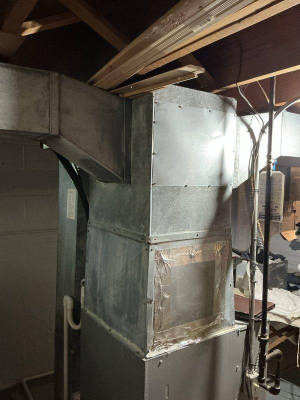 Performed comprehensive evaluation of 22-year-old residential HVAC system experiencing multiple equipment failures requiring extensive repairs. After assessing the furnace and outdoor condensing unit, presented full system replacement options to address aging equipment and avoid continued repair costs. Documented existing equipment conditions including interior furnace installation and exterior condenser with associated electrical connections and refrigerant lines.